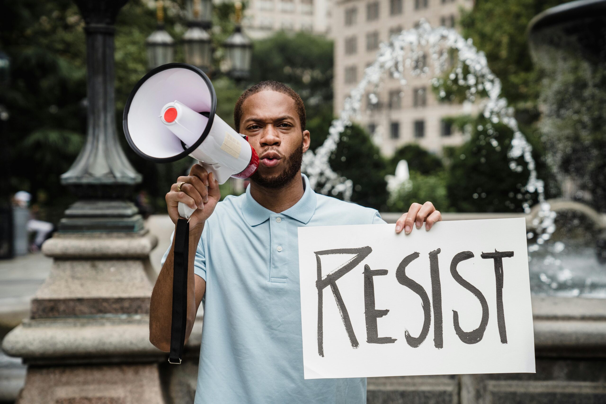 Protester holding a sign reading RESIST